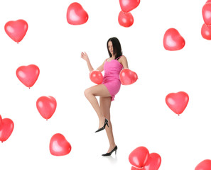 Beautiful young woman with red heart balloon