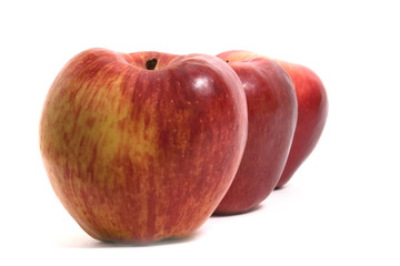 three fresh apples in a row
