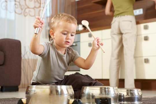 Little boy playing in kitchen