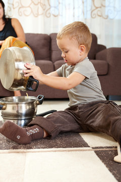 Little boy playing in kitchen