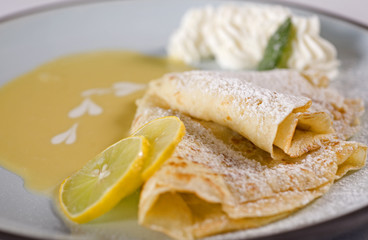 Lemon crepes with sauce and cream