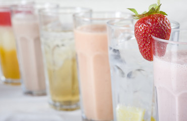 Cold fresh fruit drinks in a row