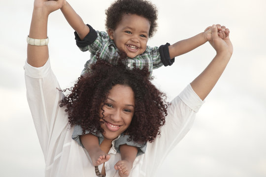 Mother Holding Her Son In The Air