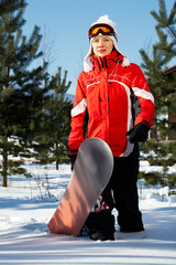 Naklejka premium female snowboarder over blue sky in forest
