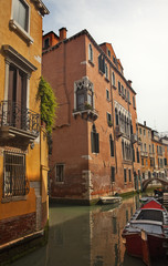 Fototapeta na wymiar Small Side Canal Boats Bridges Venice Italy
