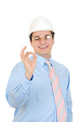 An engineer with white hard hat showing okay symbol