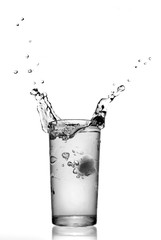 water splash in glass isolated on white
