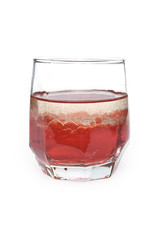glass with red liquid and bubbles of oil
