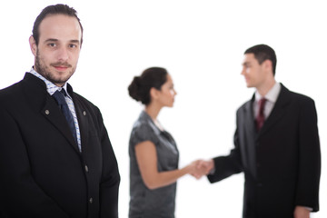 business man looking, two collegues giving shakehand