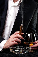 Man smoking cigar and drink cognac