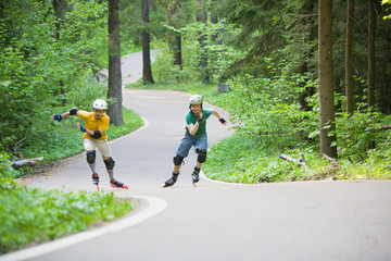 Two men rollerblading at park