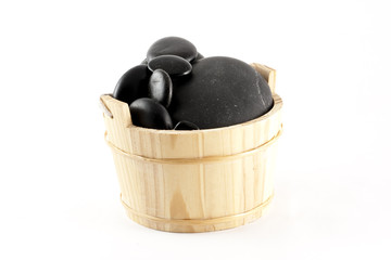 A basket filled with zen stones, isolated on white