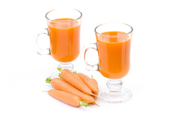 glass of fresh carrots juice and some fresh carrots
