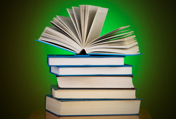 Stack of books against gradient background