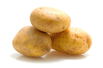 Stack of three potatoes over white background
