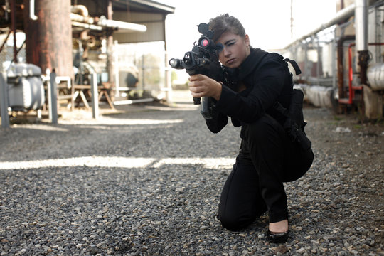 Sexy woman aiming rifle