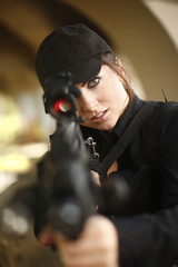 Sexy woman aiming rifle