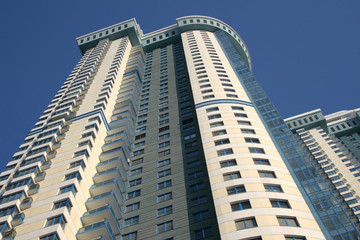 Fototapeta na wymiar The bottom view on a modern building against the blue sky