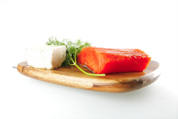 pink salmon on wooden plate with cheese