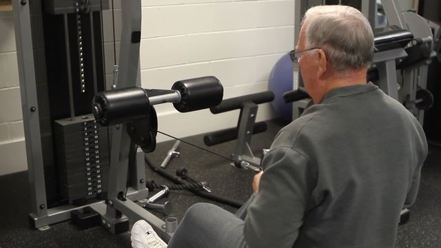Elderly Man On Row Machine