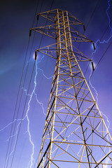 Electricity Pylon with Lightning in Background. - 20360776