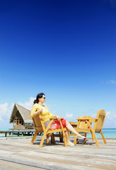 Fototapeta premium lady was sitting at chair at beach of Maldives