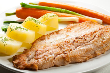 Fish dish - fried fish fillet with potatoes and vegetables