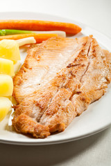 Fish dish - fried fish fillet with potatoes and vegetables