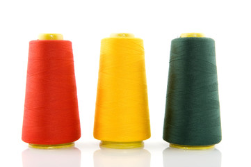 Three bobbins with threads