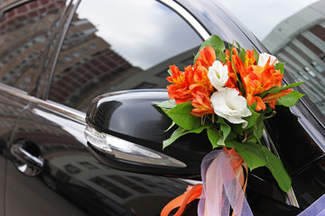 The wedding car decorated with flowers