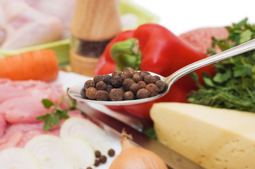 Sweet pea in a spoon against vegetables