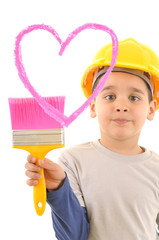 Cute boy wearing yellow helmet painting pink heart