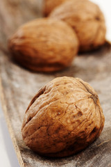 ripe walnuts on wood background