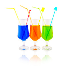 Multi-coloured cocktails in high glasses on a white background