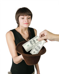The girl holds a hat in which put dollars, isolated on white