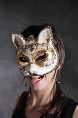 The young girl in the Venetian mask of a cat