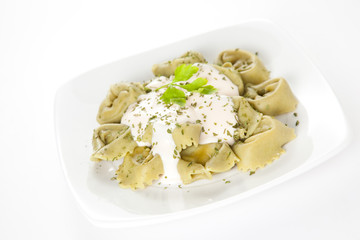 dish of tortellini with cheese sauce