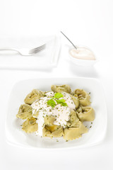 dish of tortellini with cheese sauce