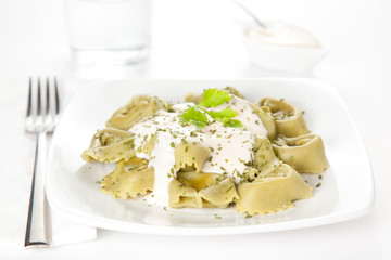 dish of tortellini with cheese sauce