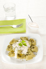 dish of tortellini with cheese sauce