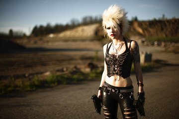 A sexy punk rocker woman with two automatic pistols.