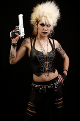 A sexy young punk rocker woman holding a pistol.