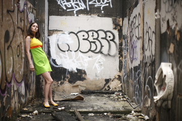 Naklejka na ściany i meble Young fashionable woman in abandoned building