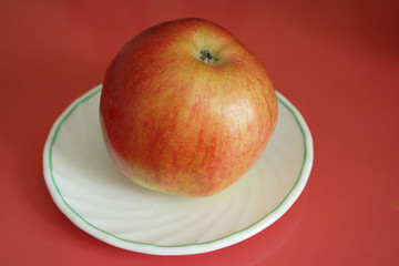 An apple on a white plate