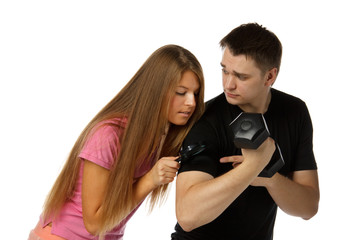 Girl considers a biceps of the man by means of a magnifier.