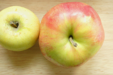 Two apples on a desk