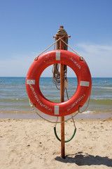 Life buoy on a beach against the sea