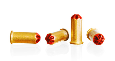 heap of golden bullets on a white background