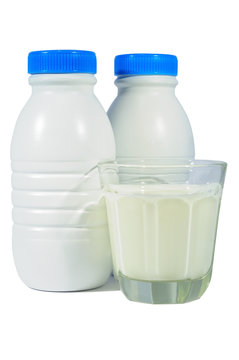 Two milk bottles and a glass of milk isolated