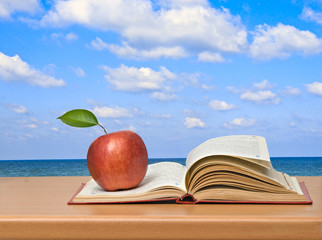 Red apples and open book